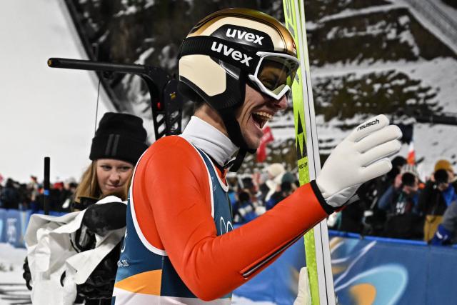 Bronze medallist Switzerland's Gregor Deschwanden celebrates after jumping during the men's ski jumping normal hill individual final round of the Milano Cortina 2026 Winter Olympic Games at Predazzo Ski Jumping Stadium in Predazzo (Val di Fiemme), on February 9, 2026. (Photo by Javier SORIANO / AFP)
