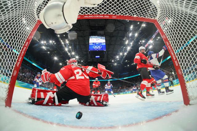 US' #08 Haley Winn (R) scores a goal past Switzerland's #20 Andrea Braendli during the women's preliminary round Group A Ice Hockey match between Switzerland and USA at the Milano Santagiulia Ice Hockey Arena at the Milano Cortina 2026 Winter Olympic Games in Milan, on February 9, 2026. (Photo by Bruce Bennett / POOL / AFP)