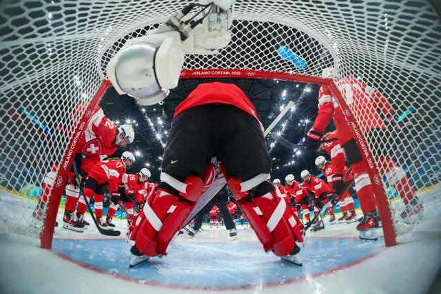 Team Switzerland players gather before the start of the women's preliminary round Group A Ice Hockey match between Switzerland and USA at the Milano Santagiulia Ice Hockey Arena at the Milano Cortina 2026 Winter Olympic Games in Milan, on February 9, 2026. (Photo by Bruce BENNETT / POOL / AFP)