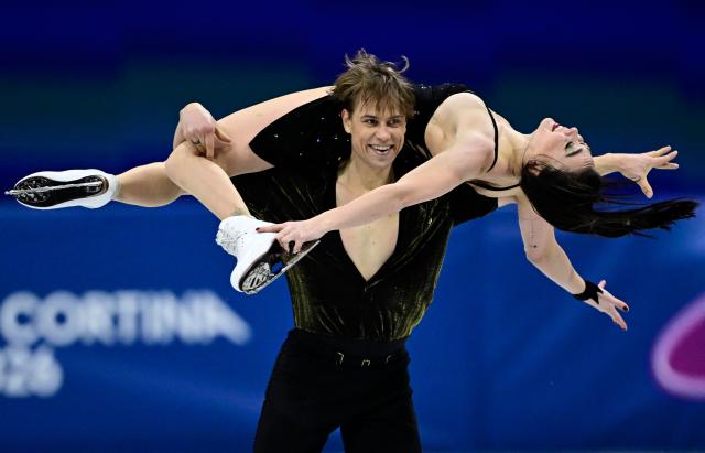 CORRECTION / Lithuania's Allison Reed and Lithuania's Saulius Ambrulevicius compete in the figure skating team event ice dance-rhythm dance during the Milano Cortina 2026 Winter Olympic Games at Milano Ice Skating Arena in Milan on February 9, 2026. (Photo by JULIEN DE ROSA / AFP) / The erroneous mention[s] appearing in the metadata of this photo by JULIEN DE ROSA has been modified in AFP systems in the following manner: [Lithuania's Allison Reed and Lithuania's Saulius Ambrulevicius] instead of [USA's Emilea Zingas and USA's Vadym Kolesnik]. Please immediately remove the erroneous mention[s] from all your online services and delete it (them) from your servers. If you have been authorized by AFP to distribute it (them) to third parties, please ensure that the same actions are carried out by them. Failure to promptly comply with these instructions will entail liability on your part for any continued or post notification usage. Therefore we thank you very much for all your attention and prompt action. We are sorry for the inconvenience this notification may cause and remain at your disposal for any further information you may require.
