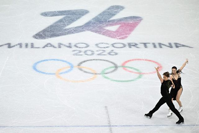 Lithuania's Allison Reed and Lithuania's Saulius Ambrulevicius compete in the figure skating team event ice dance-rhythm dance during the Milano Cortina 2026 Winter Olympic Games at Milano Ice Skating Arena in Milan on February 9, 2026. (Photo by Gabriel BOUYS / AFP)