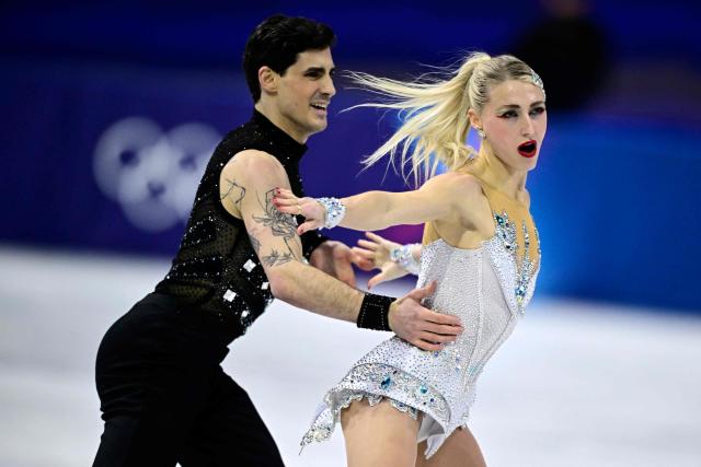 Canada's Piper Gilles and Canada's Paul Poirier compete in the figure skating team event ice dance-rhythm dance during the Milano Cortina 2026 Winter Olympic Games at Milano Ice Skating Arena in Milan on February 9, 2026. (Photo by JULIEN DE ROSA / AFP)