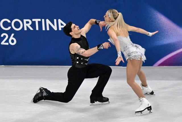 Canada's Piper Gilles and Canada's Paul Poirier compete in the figure skating team event ice dance-rhythm dance during the Milano Cortina 2026 Winter Olympic Games at Milano Ice Skating Arena in Milan on February 9, 2026. (Photo by Antonin THUILLIER / AFP)