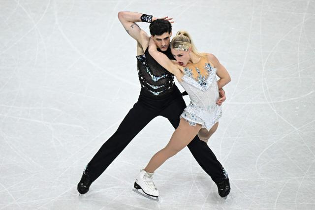 Canada's Piper Gilles and Canada's Paul Poirier compete in the figure skating team event ice dance-rhythm dance during the Milano Cortina 2026 Winter Olympic Games at Milano Ice Skating Arena in Milan on February 9, 2026. (Photo by Gabriel BOUYS / AFP)