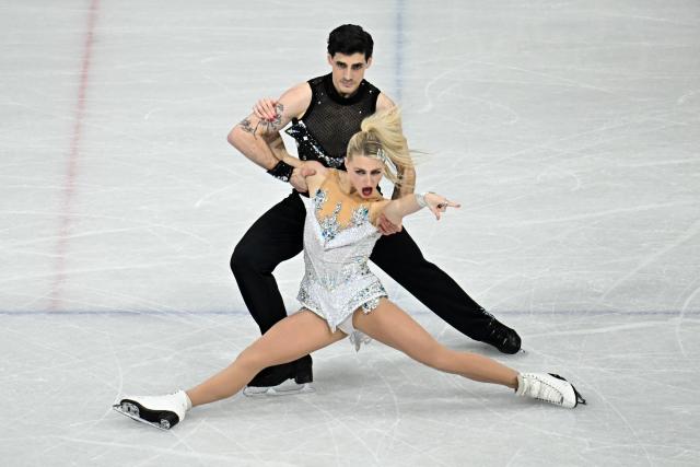 Canada's Piper Gilles and Canada's Paul Poirier compete in the figure skating team event ice dance-rhythm dance during the Milano Cortina 2026 Winter Olympic Games at Milano Ice Skating Arena in Milan on February 9, 2026. (Photo by Gabriel BOUYS / AFP)