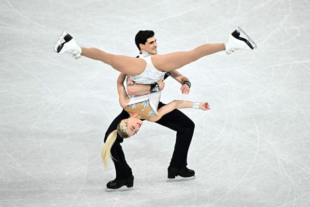 Canada's Piper Gilles and Canada's Paul Poirier compete in the figure skating team event ice dance-rhythm dance during the Milano Cortina 2026 Winter Olympic Games at Milano Ice Skating Arena in Milan on February 9, 2026. (Photo by Gabriel BOUYS / AFP)
