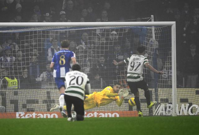 Sporting Lisbon's Colombian forward #97 Luis Suarez attempts to score his team's first goal in spite of FC Porto's Portuguese goalkeeper #99 Diogo Costa during the Portuguese League football match between FC Porto and Sporting CP at Dragao stadium in Porto, on February 9, 2026. (Photo by Miguel RIOPA / AFP)