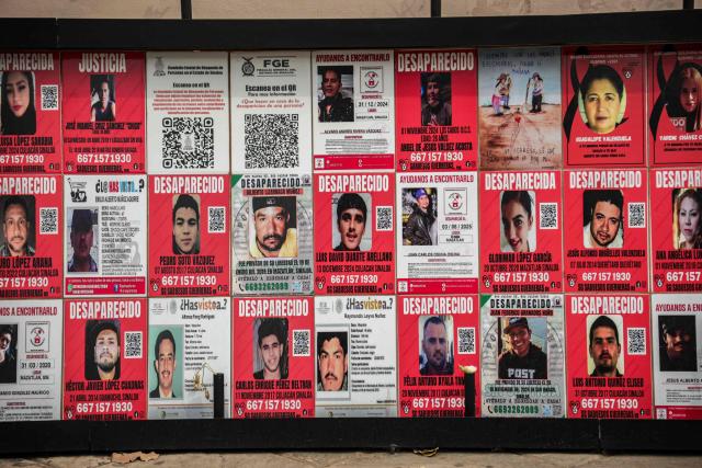 Posters that form part of a memorial to victims of enforced disappearances are seen in downtown Culiacan, Sinaloa state, Mexico, on February 9, 2026. Three of the 10 employees of a Canadian mining company who were kidnapped two weeks ago in Mexico's violence-plagued Sinaloa state have been found dead, Mexico's Mining Chamber said on February 9. (Photo by Jesus Verdugo / AFP)