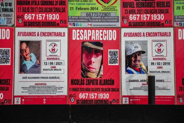 Posters that form part of a memorial to victims of enforced disappearances are seen in downtown Culiacan, Sinaloa state, Mexico, on February 9, 2026. Three of the 10 employees of a Canadian mining company who were kidnapped two weeks ago in Mexico's violence-plagued Sinaloa state have been found dead, Mexico's Mining Chamber said on February 9. (Photo by Jesus Verdugo / AFP)