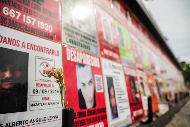 Posters that form part of a memorial to victims of enforced disappearances are seen in downtown Culiacan, Sinaloa state, Mexico, on February 9, 2026. Three of the 10 employees of a Canadian mining company who were kidnapped two weeks ago in Mexico's violence-plagued Sinaloa state have been found dead, Mexico's Mining Chamber said on February 9. (Photo by Jesus Verdugo / AFP)