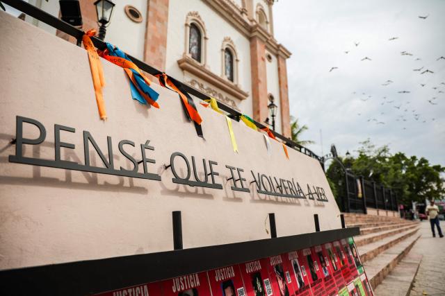 The phrase "I thought I would see you again" is seen at a memorial to victims of enforced disappearances in downtown Culiacan, Sinaloa state, Mexico, on February 9, 2026. Three of the 10 employees of a Canadian mining company who were kidnapped two weeks ago in Mexico's violence-plagued Sinaloa state have been found dead, Mexico's Mining Chamber said on February 9. (Photo by Jesus Verdugo / AFP)