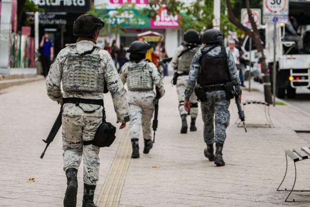 National Guard officers patrol the streets in downtown Culiacan, Sinaloa state, Mexico, on February 9, 2026. Three of the 10 employees of a Canadian mining company who were kidnapped two weeks ago in Mexico's violence-plagued Sinaloa state have been found dead, Mexico's Mining Chamber said on February 9. (Photo by Jesus Verdugo / AFP)