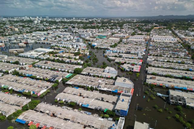 Aerial view of flooded streets in Monteria, Colombia taken on February 9, 2026. At least 13 deaths were reported this week in different parts of Colombia due to the intense rains battering the country, which are unusual for this time of year, according to a report on February 8, 2026, based on official information. (Photo by AFP)