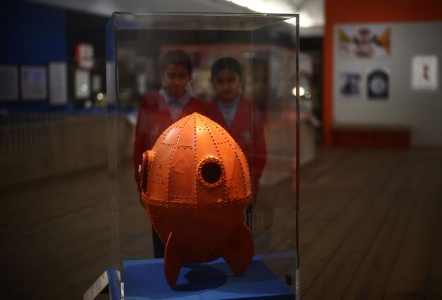 People look at the Rocket ship model used in Wallace & Gromit: A Grand Day Out, 1989', during a photocall for the Inside Aardman: Wallace & Gromit and Friends exhibition at the Young V&A museum in London on February 9, 2026, to mark the 50th anniversary of British Oscar-winning animation studio Aardman. (Photo by Henry NICHOLLS / AFP)