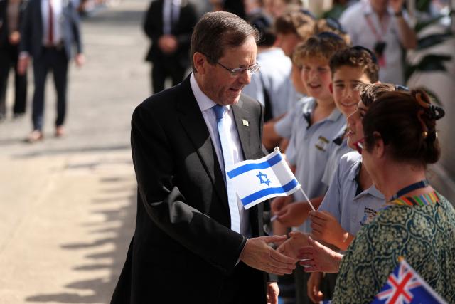 Israeli President Isaac Herzog meets students at Moriah War Memorial College during his state visit to Australia in Sydney on February 10, 2026. Herzog's tightly secured, four-day trip aims to console Australia's Jewish community after the December shooting at Sydney's Bondi Beach that killed 15 people at a Hanukkah festival. (Photo by Hollie Adams / POOL / AFP)