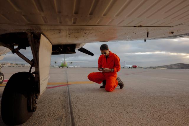 The pilot of a Humanitarian Pilot Initiative (HPI) aircraft conducts a technical check before takeoff in Las Palmas on January 23, 2026. The Swiss NGO, with 10 years of experience in central Mediterranean, is on its third mission on the Atlantic route, helping to spot distressed migrants boats and support rescues. Migrants leaving west Africa and traveling up the Atlantic are usually trying to reach Europe by first landing in the Canary Islands off northwestern Africa.
The Spanish archipelago is the jumping off point for their continued journey onward to the European continent.
More than 3,000 migrants died in 2025 while attempting to reach Spain clandestinely, according to the Spanish NGO Caminando Fronteras.
While HPI has operated for 10 years in the central Mediterranean, it is a relative newcomer to the Atlantic.
In the Mediterranean, it has already helped spot more than 1,000 boats, alerting international NGO rescue ships which can then go and help. (Photo by MICHELE CATTANI / AFP)
