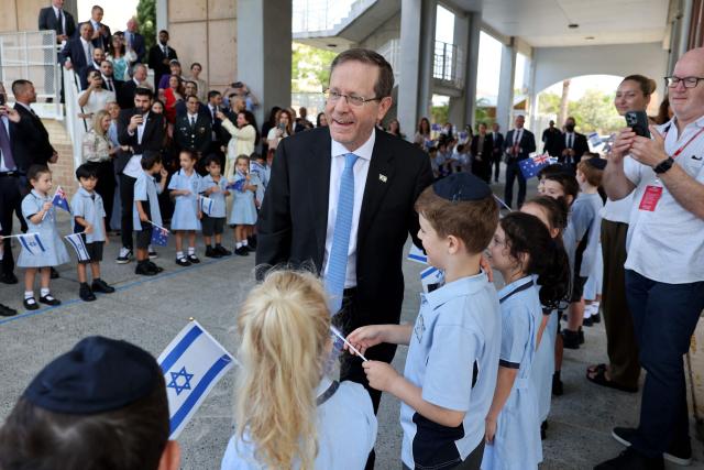 Israeli President Isaac Herzog meets students at Moriah War Memorial College during his state visit to Australia in Sydney on February 10, 2026. Herzog's tightly secured, four-day trip aims to console Australia's Jewish community after the December shooting at Sydney's Bondi Beach that killed 15 people at a Hanukkah festival. (Photo by Rohan Kelly / POOL / AFP)