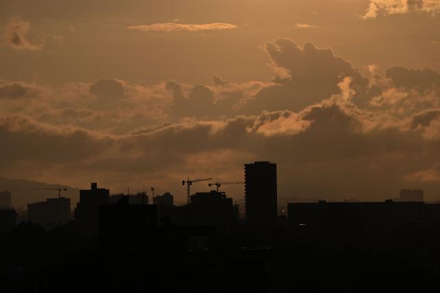 View of the city of Bogota during sunset on February 9, 2026. (Photo by Diana SANCHEZ / AFP)