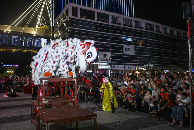 People watch as lion dancers perform during celebrations marking the Chinese Lunar in Yangon on February 9, 2026, ahead of the upcoming Lunar New Year of the Horse. (Photo by Sai Aung MAIN / AFP)