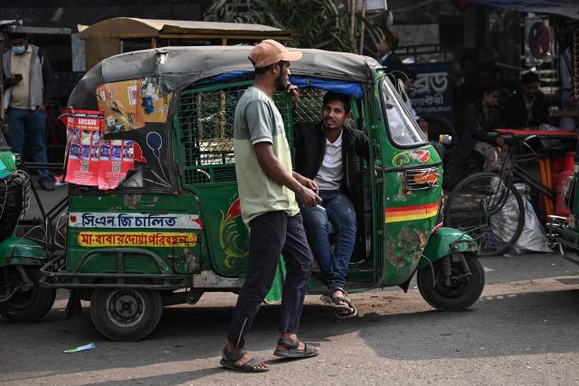 An auto rickshaw driver waits for passengers at a marketplace ahead of Bangladesh's general election in Dhaka on February 10, 2026. (Photo by Sajjad HUSSAIN / AFP)