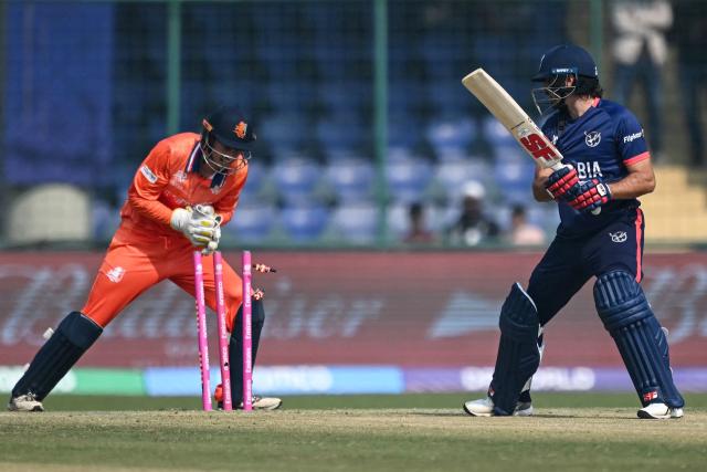 Namibia's Louren Steenkamp (R) is stumped out by Netherlands' wicketkeeper and captain Scott Edwards during the 2026 ICC Men's T20 Cricket World Cup group stage match between Netherlands and Namibia at the Arun Jaitley Stadium in New Delhi on February 10, 2026. (Photo by Arun SANKAR / AFP)