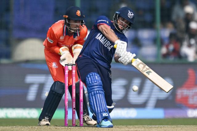 Namibia's Jan Nicol Loftie-Eaton (R) plays a shot as Netherlands' wicketkeeper and captain Scott Edwards watches during the 2026 ICC Men's T20 Cricket World Cup group stage match between Netherlands and Namibia at the Arun Jaitley Stadium in New Delhi on February 10, 2026. (Photo by Arun SANKAR / AFP)