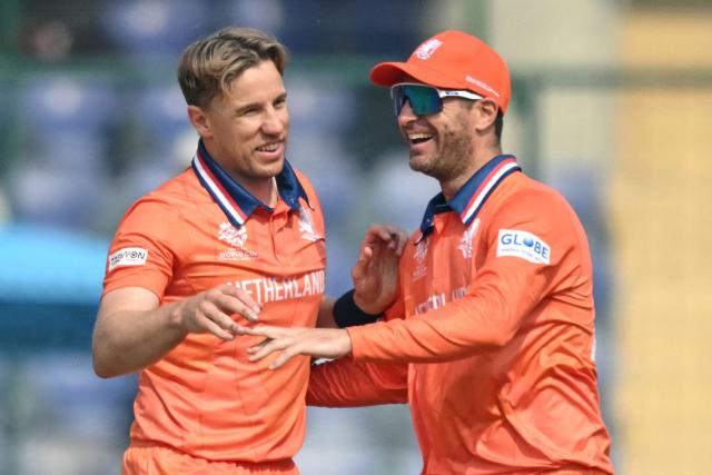 Netherlands' Logan van Beek (L) celebrates with teammate after taking the wicket of Namibia's Jan Frylinck during the 2026 ICC Men's T20 Cricket World Cup group stage match between Netherlands and Namibia at the Arun Jaitley Stadium in New Delhi on February 10, 2026. (Photo by Arun SANKAR / AFP)
