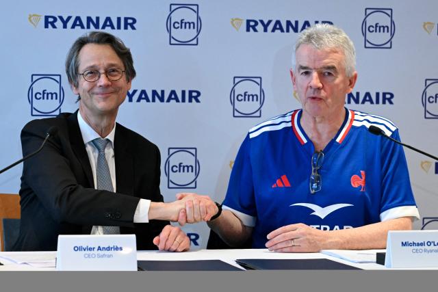 Chief Executive Officer of French aerospace supplier Safran Olivier Andries (L) and Chief executive of lowcost airline Ryanair, Michael O'Leary shake hands during a press conference to present a new partnership in Paris on February 10, 2026. (Photo by Bertrand GUAY / AFP)