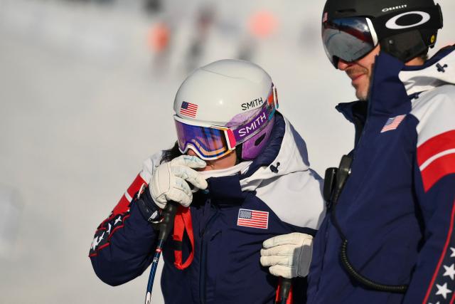 US' Breezy Johnson (L) inspects the course prior to the downhill run of the women's team combined event during the Milano Cortina 2026 Winter Olympic Games at the Tofane Alpine Skiing Centre in Cortina d’Ampezzo on February 10, 2026. (Photo by Marco BERTORELLO / AFP)