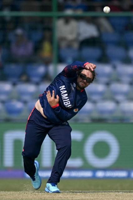 Namibia's Jan Nicol Loftie-Eaton delivers a ball during the 2026 ICC Men's T20 Cricket World Cup group stage match between Netherlands and Namibia at the Arun Jaitley Stadium in New Delhi on February 10, 2026. (Photo by Arun SANKAR / AFP)