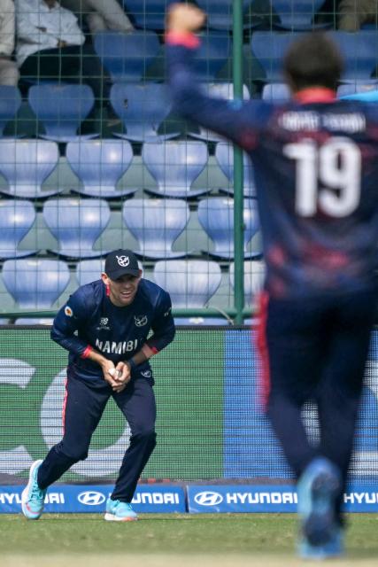 Namibia's captain Gerhard Erasmus takes a catch to dismiss Netherlands' Colin Ackermann during the 2026 ICC Men's T20 Cricket World Cup group stage match between Netherlands and Namibia at the Arun Jaitley Stadium in New Delhi on February 10, 2026. (Photo by Arun SANKAR / AFP)