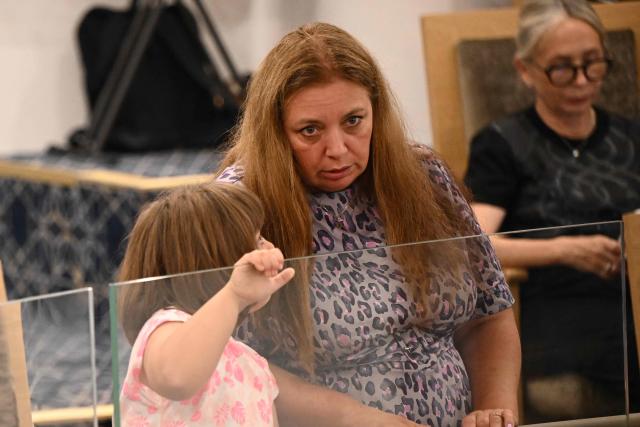 Valentyna Poltavchenko, mother of victim Matilda, attends a service with Israel's President Isaac Herzog as he meets with victims of the Bondi terrorist attack and members of the local Jewish community at the Chabad of Bondi in Sydney on February 10, 2026. Herzog's tightly secured, four-day trip aims to console Australia's Jewish community after the December shooting at Sydney's Bondi Beach that killed 15 people at a Hanukkah festival. (Photo by BIANCA DE MARCHI / POOL / AFP)