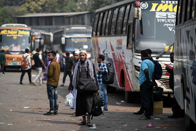 People arrive to buy tickets at a bus terminal in Dhaka on February 10, 2026, as they head to their hometowns to cast their votes ahead of Bangladesh's general election. (Photo by Sajjad HUSSAIN / AFP)