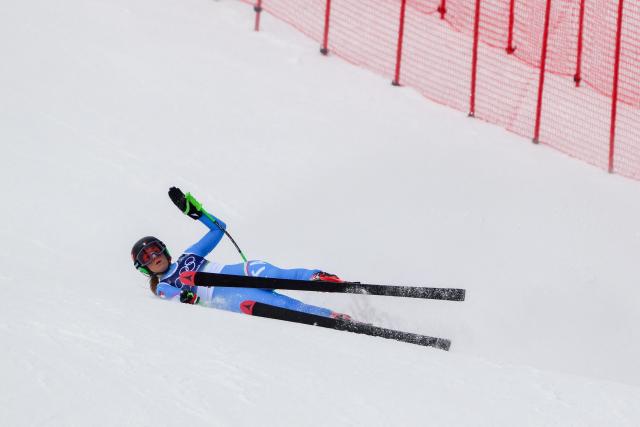 Italy's Sofia Goggia crashes as she competes in the downhill run of the women's team combined event during the Milano Cortina 2026 Winter Olympic Games at the Tofane Alpine Skiing Centre in Cortina d’Ampezzo on February 10, 2026. (Photo by Marco BERTORELLO / AFP)