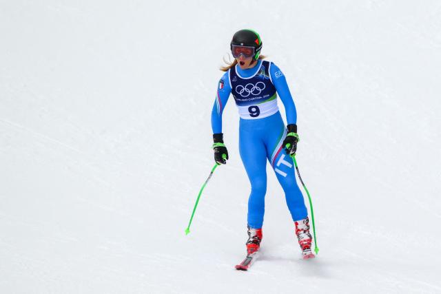 Italy's Sofia Goggia reacts after crashing in the downhill run of the women's team combined event during the Milano Cortina 2026 Winter Olympic Games at the Tofane Alpine Skiing Centre in Cortina d’Ampezzo on February 10, 2026. (Photo by Marco BERTORELLO / AFP)