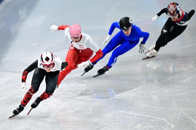 Canada's Kim Boutin, Poland's Natalia Maliszewska, Individual Neutral Athlete Alena Krylova and South Korea's Lee So-yeon compete in the short track speed skating women's 500m heats during the Milano Cortina 2026 Winter Olympic Games at Milano Ice Skating Arena in Milan on February 10, 2026. (Photo by JULIEN DE ROSA / AFP)