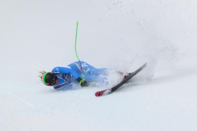 Italy's Sofia Goggia crashes as she competes in the downhill run of the women's team combined event during the Milano Cortina 2026 Winter Olympic Games at the Tofane Alpine Skiing Centre in Cortina d’Ampezzo on February 10, 2026. (Photo by Marco BERTORELLO / AFP)