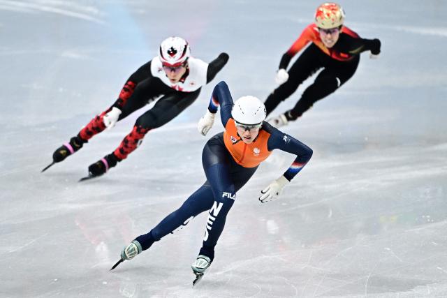 Netherlands' Selma Poutsma(C), Canada's Florence Brunelle (L) and China's Fan Kexin compete in the short track speed skating women's 500m heats during the Milano Cortina 2026 Winter Olympic Games at Milano Ice Skating Arena in Milan on February 10, 2026. (Photo by JULIEN DE ROSA / AFP)