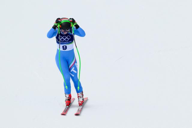 Italy's Sofia Goggia reacts after crashing in the downhill run of the women's team combined event during the Milano Cortina 2026 Winter Olympic Games at the Tofane Alpine Skiing Centre in Cortina d’Ampezzo on February 10, 2026. (Photo by Marco BERTORELLO / AFP)
