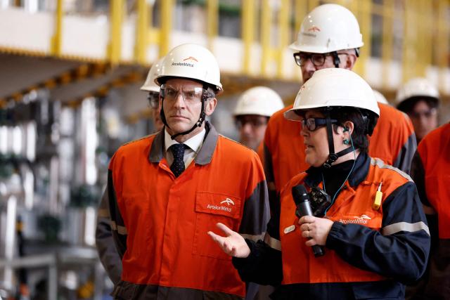 France's President Emmanuel Macron (L) looks on as he visits the new production lines at ArcelorMittals's new electric steel production facility in Mardyck, nothern France on February 10, 2026. (Photo by Benoit Tessier / POOL / AFP)