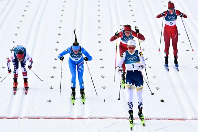 Sweden's Linn Svahn crosses the finish line ahead of Italy's Caterina Ganz (2ndL) after competing in heat 2 of the women's cross country sprint classic quarterfinals event of the Milano Cortina 2026 Winter Olympic Games at Tesero Cross-Country Skiing Stadium in Lago di Tesero (Val di Fiemme), on February 10, 2026. (Photo by Tobias SCHWARZ / AFP)