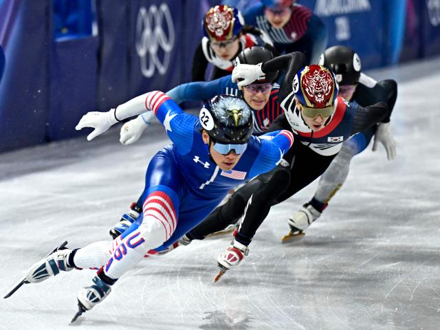 US' Andrew Heo and South Korea's Shin Dong-min compete in the short track speed skating mixed team relay quarter-final during the Milano Cortina 2026 Winter Olympic Games at Milano Ice Skating Arena in Milan on February 10, 2026. (Photo by Gabriel BOUYS / AFP)