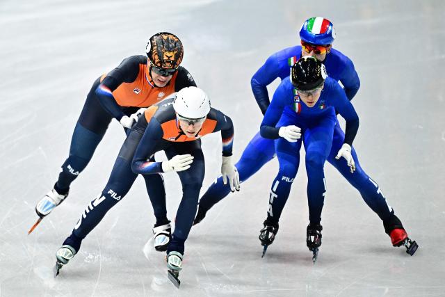 Netherlands' Jens van T Wout and Selma Poutsma and Italy's Pietro Sighel and Arianna Fontana compete in the short track speed skating mixed team relay quarter-final during the Milano Cortina 2026 Winter Olympic Games at Milano Ice Skating Arena in Milan on February 10, 2026. (Photo by JULIEN DE ROSA / AFP)