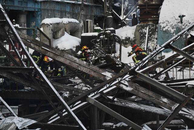Rescuers of the State Emergency Service and employees of a power plant clear debris at a heavily damaged thermal power plant of the Ukrainian energy provider DTEK in an undisclosed location in Ukraine on February 9, 2026, following Russian missile and drone strikes amid the Russian invasion of Ukraine. (Photo by Genya SAVILOV / AFP)