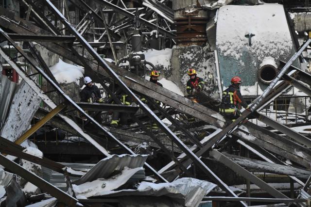 Rescuers of the State Emergency Service and employees of a power plant clear debris at a heavily damaged thermal power plant of the Ukrainian energy provider DTEK in an undisclosed location in Ukraine on February 9, 2026, following Russian missile and drone strikes amid the Russian invasion of Ukraine. (Photo by Genya SAVILOV / AFP)