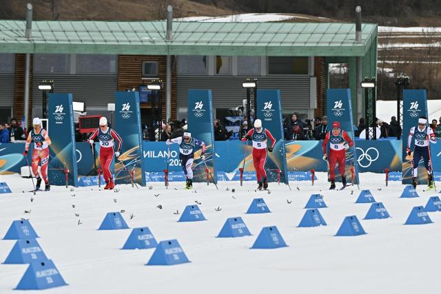 (From L) Spain's Bernat Selles Gasch, Norway's Oskar Opstad Vike, France's Richard Jouve, Norway's Harald Oestberg Amundsen, Switzerland's Valerio Grond and USA's Jc Schoonmaker take the start of heat 4 of the men's cross country sprint classic quarterfinal event of the Milano Cortina 2026 Winter Olympic Games at Tesero Cross-Country Skiing Stadium in Lago di Tesero (Val di Fiemme), on February 10, 2026. (Photo by Javier SORIANO / AFP)