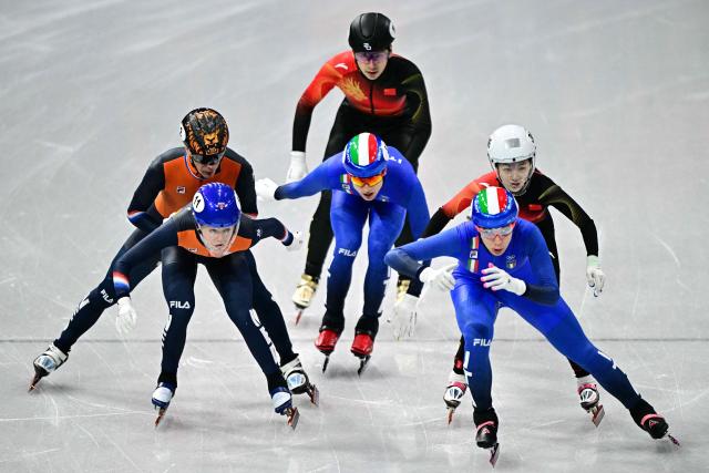Team Netherlands' Jens van T Wout and Netherlands' Michelle Velzeboer, Team Italy's Pietro Sighel and Arianna Fontana and team China's Lin Xiaojun and Liu Shaoang compete in the short track speed skating mixed team relay semi-final during the Milano Cortina 2026 Winter Olympic Games at Milano Ice Skating Arena in Milan on February 10, 2026. (Photo by JULIEN DE ROSA / AFP)