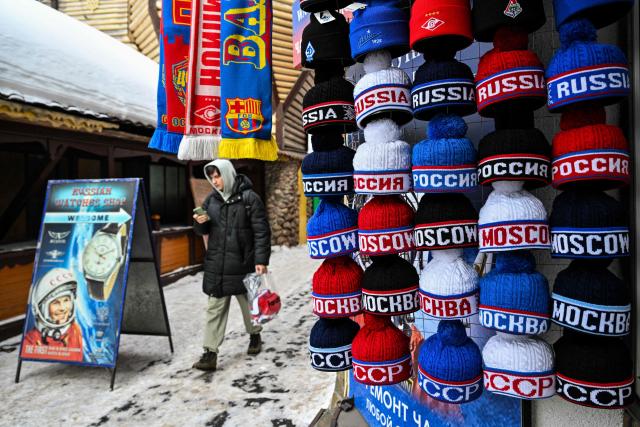 Hats reading Russia and Moscow are displayed for sale in a shop at Izmailovo market in Moscow on February 10, 2026. (Photo by Hector RETAMAL / AFP)