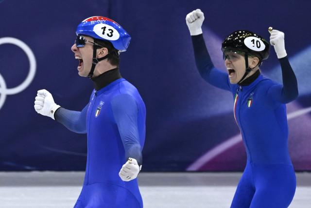 Team Italy's Thomas Nadalini and Arianna Fontana celebrate after winning gold in the short track speed skating mixed team relay final during the Milano Cortina 2026 Winter Olympic Games at Milano Ice Skating Arena in Milan on February 10, 2026. (Photo by WANG Zhao / AFP)