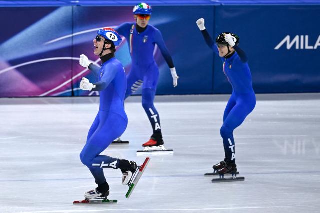 Team Italy's Thomas Nadalini, Pietro Sighel and Arianna Fontana celebrate after winning gold in the short track speed skating mixed team relay final during the Milano Cortina 2026 Winter Olympic Games at Milano Ice Skating Arena in Milan on February 10, 2026. (Photo by WANG Zhao / AFP)